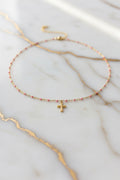 Collier perlé croix